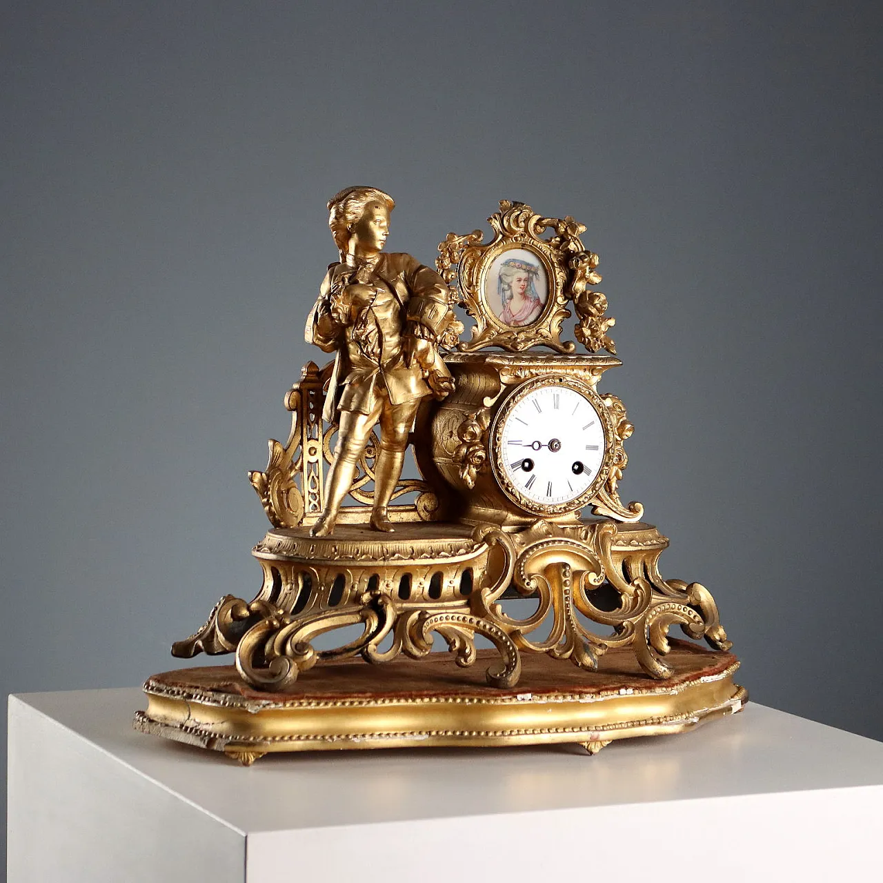 Golden antimony clock on wooden base, 20h century 1