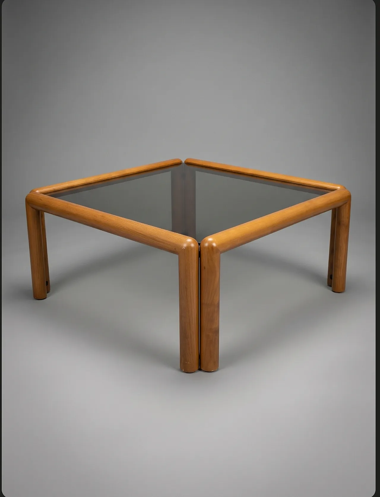 Square coffee table with rounded wooden structure and glass top 1