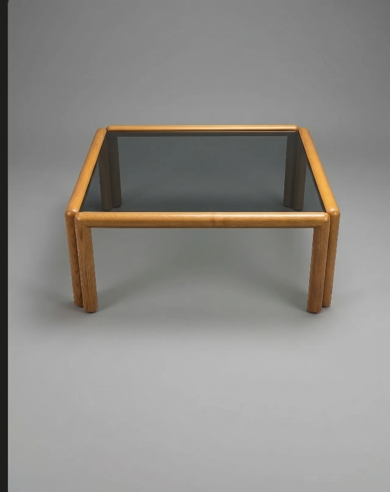 Square coffee table with rounded wooden structure and glass top 2