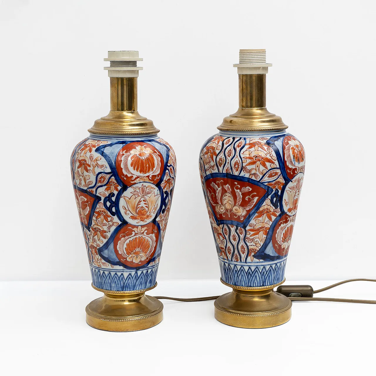 Pair of Imari Meiji porcelain vases with gilt bronze supports, 19th c. 1