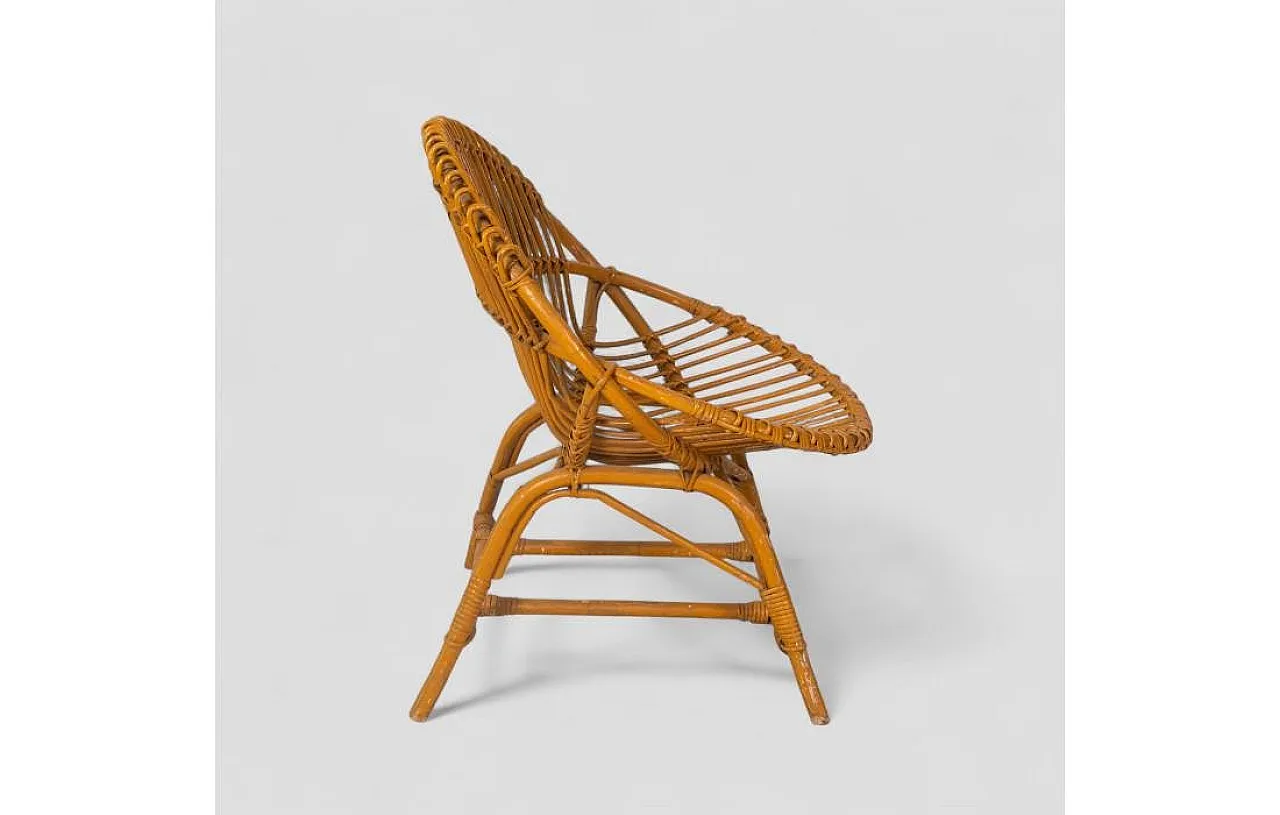 Curved shell armchair in rattan, 1970s 4