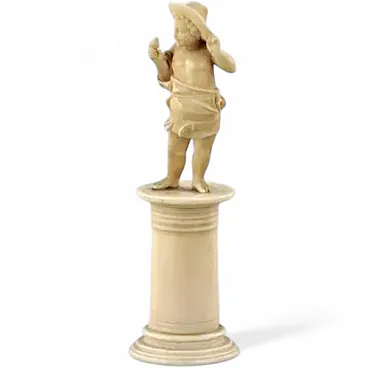 Carved ivory figurine of boy with bird, 19th century